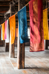 Poster - Vibrant Fabric Banners Hanging in Rustic Wooden Interior Reflecting Cultural Heritage : Generative AI