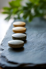 Fototapete - Arrangement of smooth stone pebbles on slate reflecting zen relaxation : Generative AI