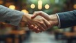 © Sang - Two business partners shake hands after a successful negotiation, celebrating their agreement and closing a business contract with a handshake