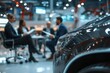 © Image Tree - Business professionals discussing automotive innovations in a modern showroom
