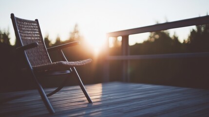 Wall Mural - Eco friendly rattan rocking chair on wooden deck at golden hour in a sustainable outdoor setting