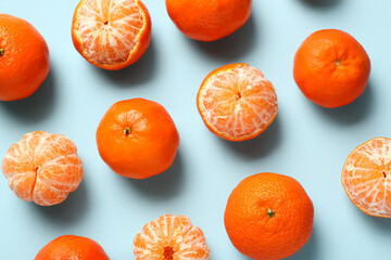 Wall Mural - Fresh tangerines on blue background