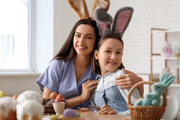 Sticker - Little girl and her mother in bunny ears celebrating Easter at kitchen