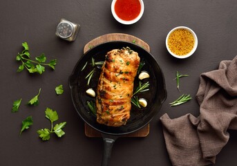 Wall Mural - Roasted pork loin with rosemary and garlic in cast iron pan