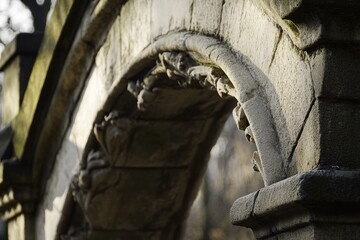 Poster - A stone arch with a lion's head on it, often found in ancient architecture
