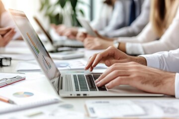 Poster - Group of people using laptops at a table, concept of remote work and collaboration