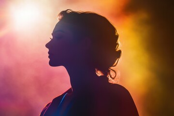 Wall Mural - a woman stands in front of a bright light, possibly a stage or spotlight