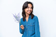 © luismolinero - Young hispanic woman holding lavender isolated on white background thinking an idea while looking up