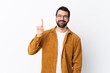 © luismolinero - Caucasian handsome man with beard wearing a corduroy jacket over isolated white background showing and lifting a finger in sign of the best
