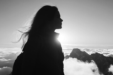 Wall Mural - A person stands on top of a mountain, gazing up at the sky