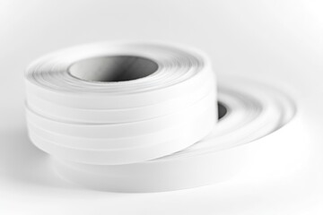 Poster - A roll of white tape sitting on a table, ready for use