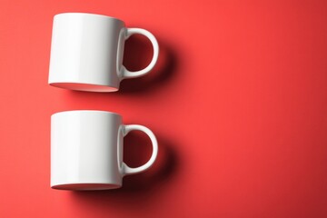 Aufkleber - Two ceramic cups placed side by side on a vibrant red background