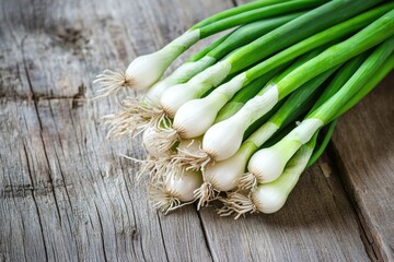 Poster - Fresh green onions arranged on a wooden table, ideal for cooking or decoration