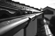 © Fotograf - A close-up view of a rain gutter in black and white