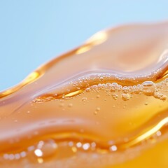 Wall Mural - golden fluid waves with bubbles against bright blue background