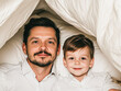 © Kowit - Father and son bonding home family portrait cozy setting close-up connection
