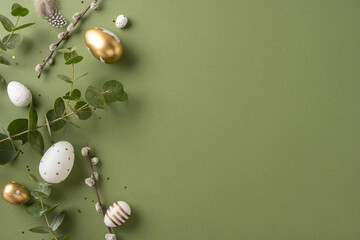 Wall Mural - decorative easter eggs in various designs scattered on a surface with green leaves