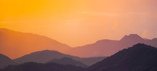 Wall Mural - Beautiful sunrise misty mountain layers, silhouettes on the horizon
