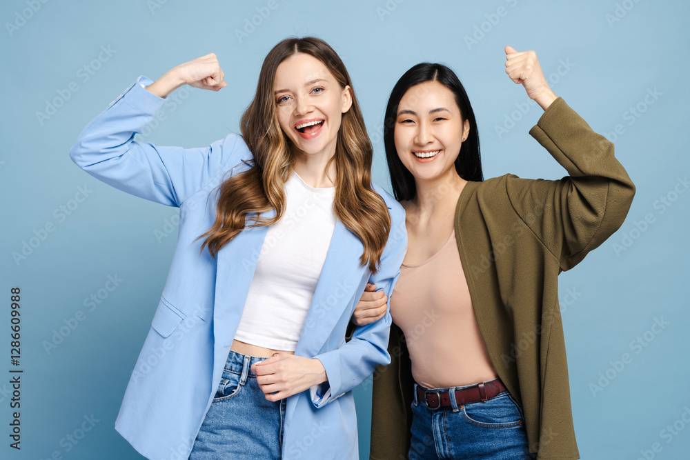 Two happy businesswomen showing strength and celebrating success Stock ...