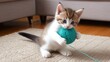 © Kasivat - A kitten plays with a ball of yarn on a rug.