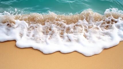 Wall Mural - Aerial view capturing a wave gracefully approaching the sandy beach, highlighting the dynamic movement of water and the serene coastal landscape.