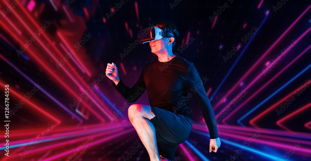 Asian man wearing VR headset while exercising at an abstract background ...