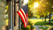 © abu - An American flag hangs near a suburban home’s entrance, fluttering in a peaceful summer breeze.