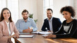© fizkes - Four business partners take part in meeting gathered at conference table, smile, look at camera engaged in virtual videocall negotiations with shareholders for exchanging information. Staff portrait