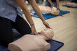© bunyarit - Close-up of Asian hands practicing cardiopulmonary resuscitation (CPR) on a training dummy. Important techniques include chest compressions and maintaining an airway.