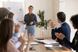 © fizkes - Motivated staff members applauding young Indian female business trainer after successful presentation, thanking leader for effective meeting or collaboration, giving positive feedback, welcoming coach