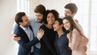 © fizkes - Six diverse workmates hugging indoors, gesture of camaraderie and celebration of achieving goal. Team spirit and mutual support, strong interpersonal relationships, trust, positive work environment