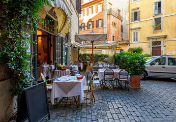 Wall Mural - view of old narrow street with tables of restaurant in rome, italy. architecture and landmark of rom