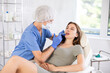© JackF - Hands of cosmetologist making filler injection in female lips. Young woman is receiving procedure with enjoy.