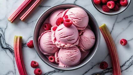 Aufkleber - Rhubarb ice cream topped with fresh raspberries in a bowl on a marble background with rhubarb stalks, showcasing a delicious summer treat.