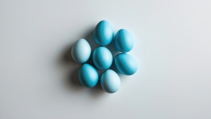 Poster - Blue Eggs Arranged in a Creative Layout on a White Background Perfect for Minimalist Photography, Flat Lay Designs and Mockup Projects