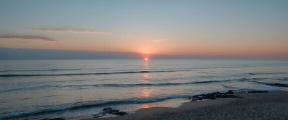 Poster - Serene Minimalist Seascape at Coastal Sunrise with Soft Waves and Gentle Colors Reflecting in Calm Waters.