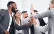© Prostock-studio - Team achievement, diverse business people giving high five at meeting