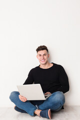 Poster - Freelance work with laptop, young man in casual typing on keyboard, copy space on white