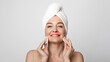 © Prostock-studio - Skin care in senior age. Beautiful mature lady with towel on head cleaning her face with lotion and cotton pads and smiling at camera, free space