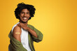 © Prostock-studio - Vaccination Concept. Cheerful Black Guy Demonstrating Arm With Adhesive Bandage After Covid-19 Vaccine Shot, Happy African Man Protecting Himself From Coronavirus, Posing Over Beige Background