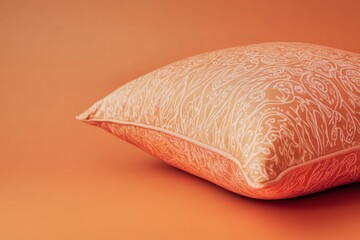 Wall Mural - A decorative orange pillow against a solid light orange background