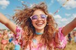 © kvladimirv - Cheerful Young Woman Celebrating at Outdoor Festival with Colorful Sunglasses and Curly Hair