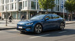 © Janos - A modern concept of an electric car on a city street.