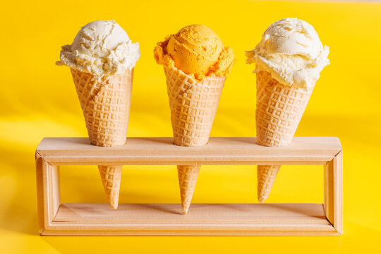 Fototapete -  - A refreshing ice cream cones set against a vibrant yellow background