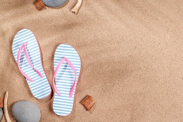 Fototapete - A tropical summer background featuring beach sand with palm leaf shadows and a pair of flip-flops