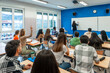 © unai - Students raising hand and following lesson in university classroom