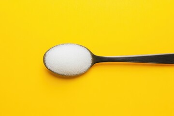 Wall Mural - A Spoonful Of Sugar Lies On A Bright Yellow Surface