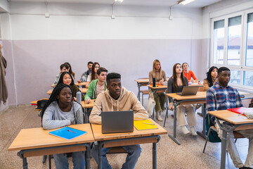 Wall Mural - High school students attending class and learning with laptop computers