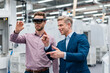 © Westend61 - Two businessmen with AR glasses in a modern factory