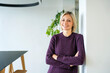 © Westend61 - Portrait of a smiling woman in a modern office setting